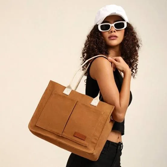 Ben Classic Handbag in tan canvas, carried over the shoulder